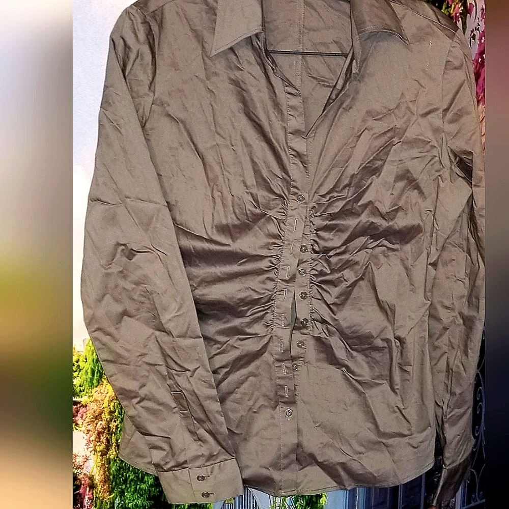 Grey button down shirt. Side hems give hour glass shape to the waist. (offers)